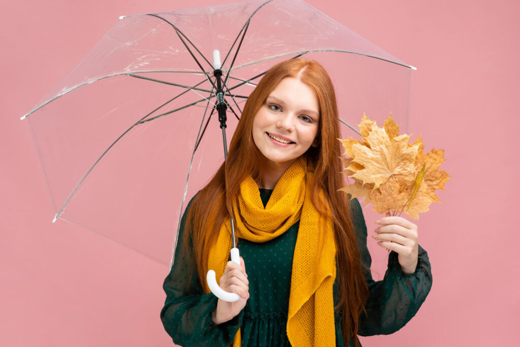 front-view-smiley-woman-holding-umbrella-1024x684